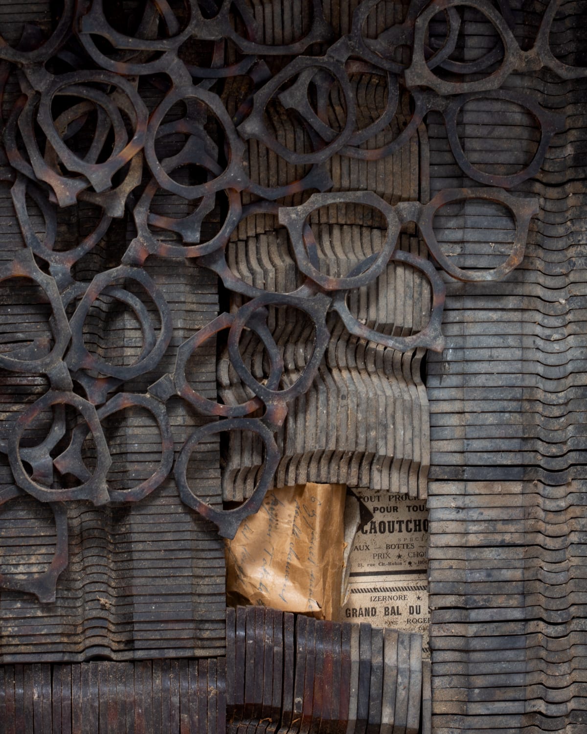 A box full of celluloid fronts from the fifties, wrapped in newspaper from 1965.